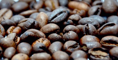 Close-up of roasted coffee beans on table