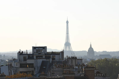 Buildings in city against clear sky