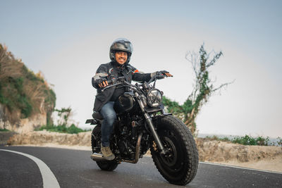 Man riding motorcycle on road