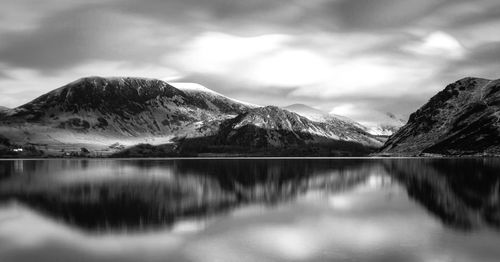 Scenic view of lake and mountains against sky