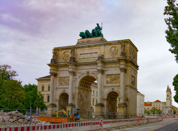 Low angle view of historical building against cloudy sky