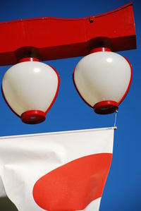 Low angle view of lantern against blue sky