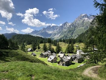 Scenic view of field and mountains against sky