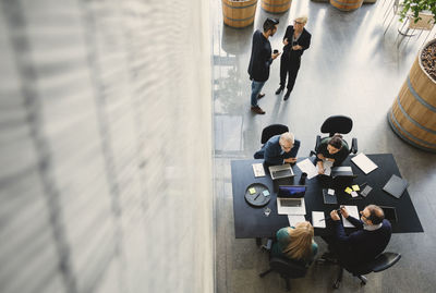 High angle view of business people working in creative office