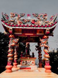 Statue of temple against building