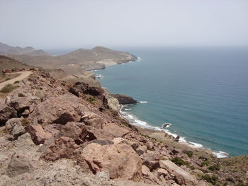 Scenic view of sea and mountains against sky