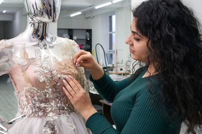 Side view of woman looking at store