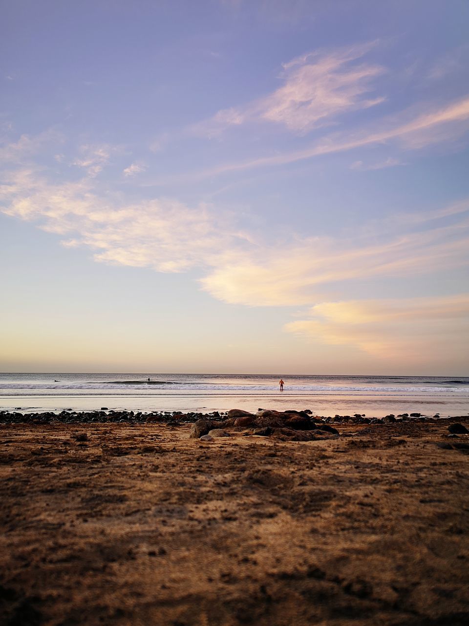 SCENIC VIEW OF BEACH AGAINST SKY AT SUNSET