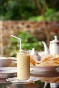 Close-up of banana milkshakes on breakfast table