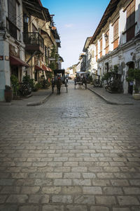 People on street amidst buildings in city