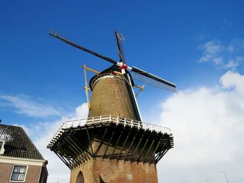 Low angle view of traditional windmill against sky