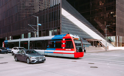 Car on street against buildings in city
