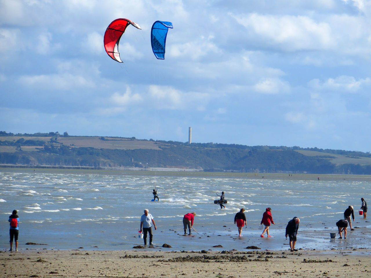 PEOPLE SURFING ON BEACH