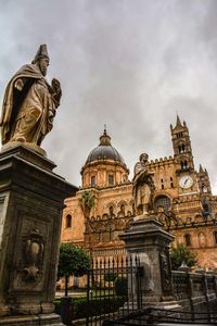 Low angle view of church against cloudy sky