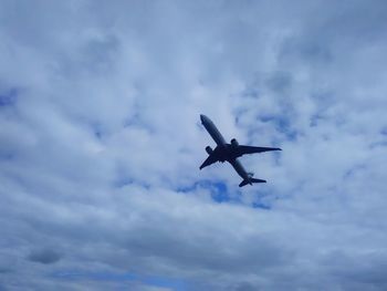 Low angle view of airplane flying in sky