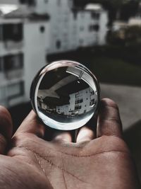 Close-up of hand holding crystal ball