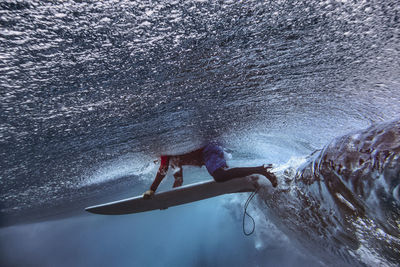 Male surfer with surfboard in sea