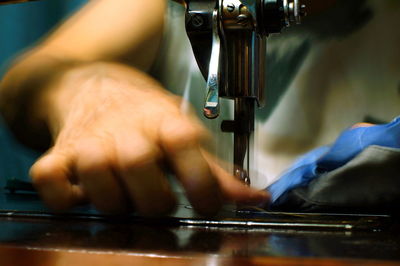 Cropped image of tailor stitching on sewing machine