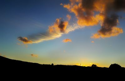 Silhouette of trees against sky at sunset