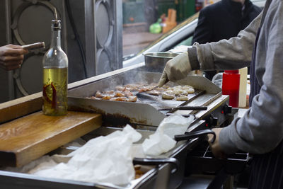 Midsection of man preparing food in restaurant