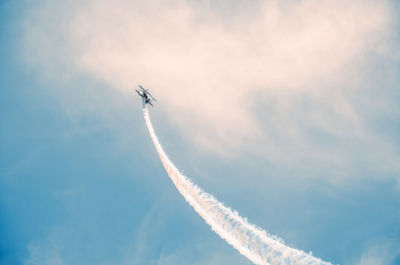 Low angle view of airshow in blue sky