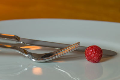 Close-up of strawberries on table against white background