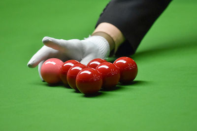 Cropped hand of person playing pool