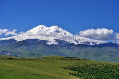 Elbrus mountain. scenic view of snowcapped mountains against sky