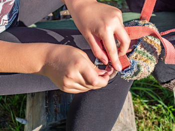 Close-up of child holding belt