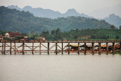 Scenic view of river by mountains against sky