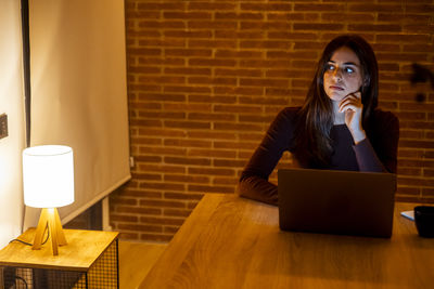 Young woman using laptop on table