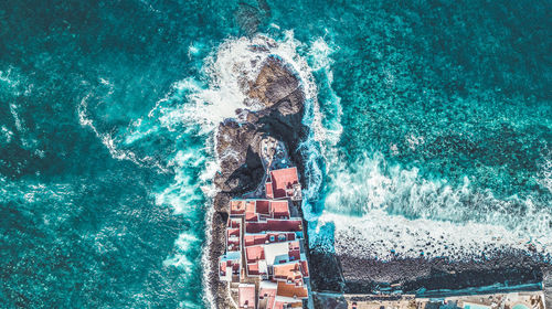 Man swimming in pool by sea