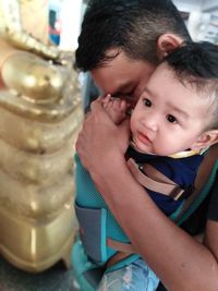 Father and son praying in temple