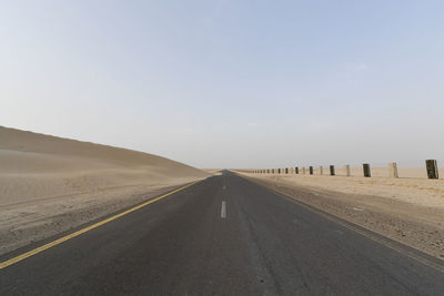 Empty road against clear sky