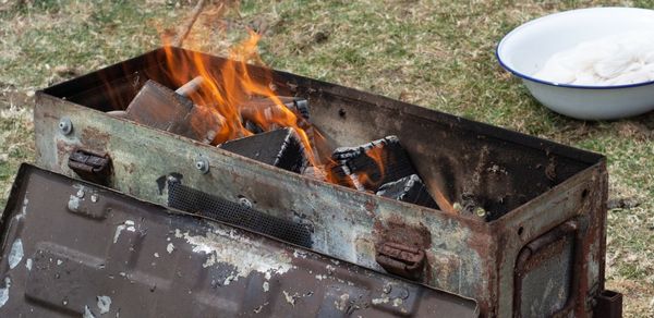 High angle view of fire on barbecue grill