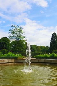 Water splashing in fountain against sky