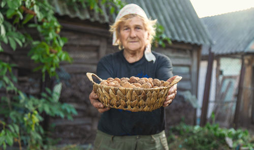 Portrait of smiling young woman holding plant