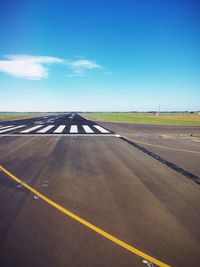 Empty road against blue sky