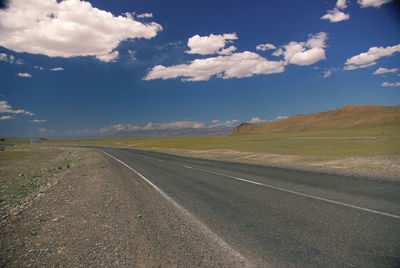 Empty road along countryside landscape