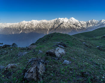 Scenic view of snowcapped mountains against blue sky