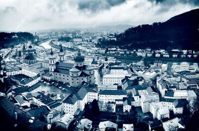 View of cityscape against cloudy sky