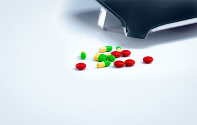 Close-up of multi colored candies against white background