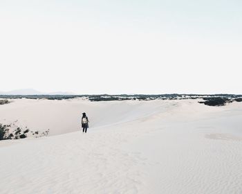 Tourists on snow covered landscape