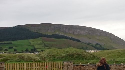 Scenic view of mountains against cloudy sky