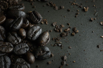 High angle view of coffee beans on sand