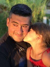 Close-up of girl kissing father