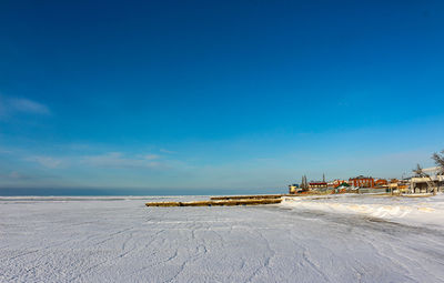 Scenic view of beach against blue sky