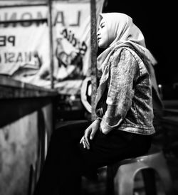 Side view of woman wearing hijab at night