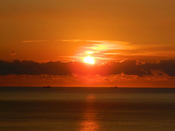 Scenic view of sea against romantic sky at sunset