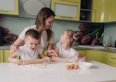 Mother and daughter on table at home